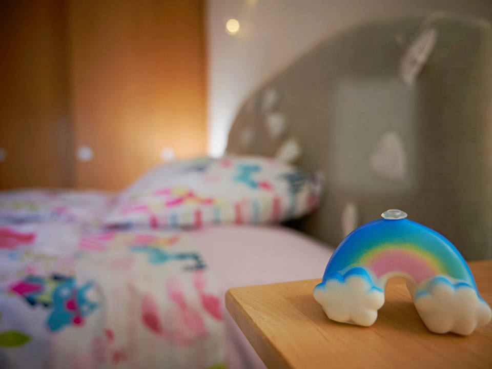 A bedroom interior focussing on a rainbow light